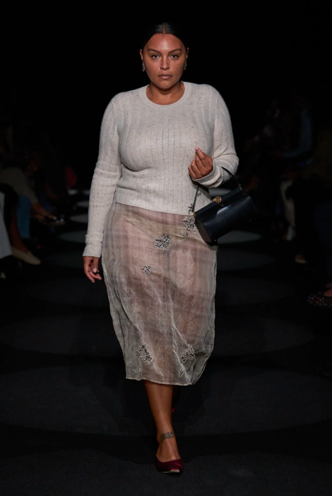 model wearing a naked skirt with a sweater on the ramp